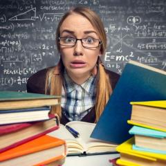student sitting with books