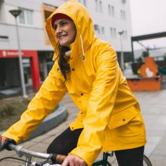 Woman cycling in rain