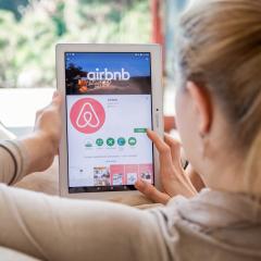 A woman browses a website on a tablet