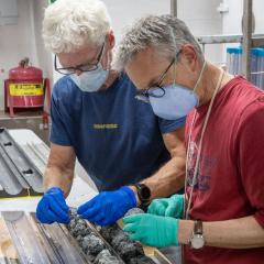Professor Southam observing rocks with a colleague